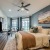 a bedroom with a bed and a fan