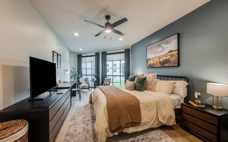 a bedroom with a bed and a fan